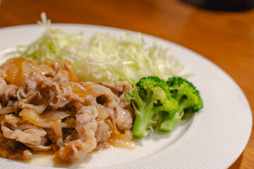Japanese dinner with pork ginger stir fry and shredded cabbage
