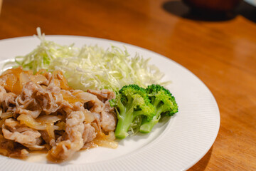 Japanese dinner with pork ginger stir fry and shredded cabbage
