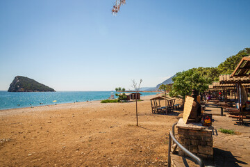 Beach with Island, Sea, and Wooden Seating Area on Coastline