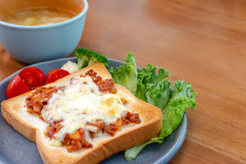 Breakfast with cheese toast and vegetables
