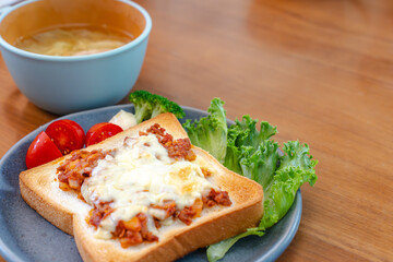 Breakfast with cheese toast and vegetables
