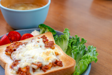 Breakfast with cheese toast and vegetables
