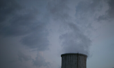 steam and smoke coming from industrial pipes