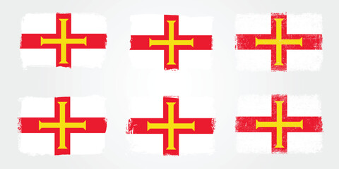 Obraz premium Grunge brush variations of the Guernsey Norman cross flag