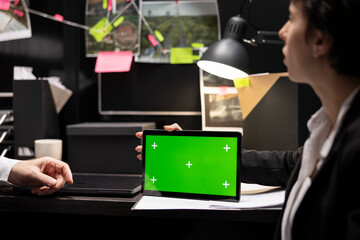 Team of investigators using an isolated copy space screen on tablet in incident room, working hard...