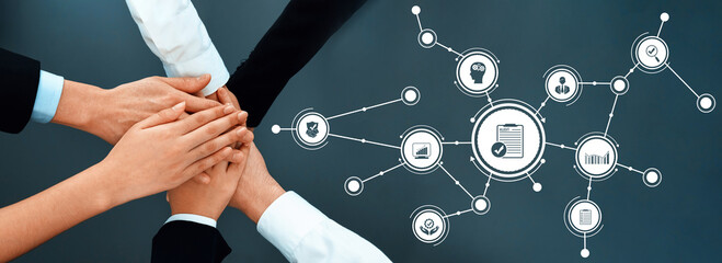 This image illustrates multiple hands joining together to symbolize teamwork and collaboration,...