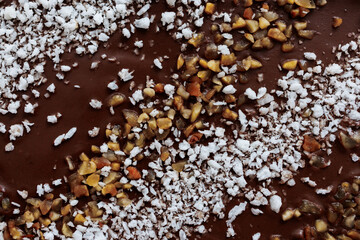 Sweet topping made of chocolate, coconut and caramelized nuts