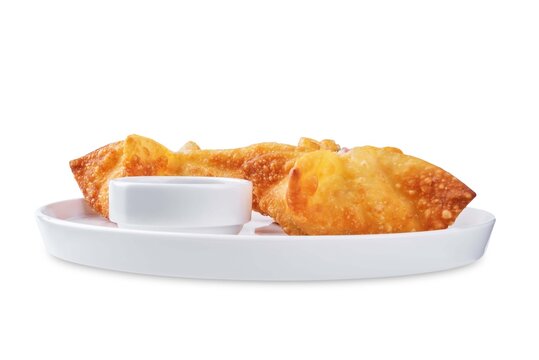 Crab rangoon with sauce in a plate on a white isolated background