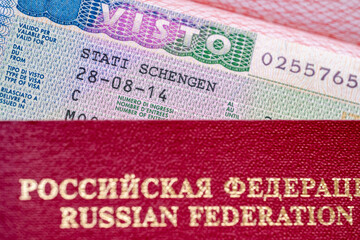 Schengen visa allows multiple entry to European Union, red Russian Federation passport in focus, travel ban restrictions and denied visas for Russian citizens, travel freedom across Europe