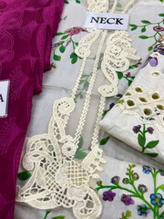 Floral Embroidered Fabric with Cutwork Detailing, Close-up of embroidered fabric featuring floral patterns and lace-style cutwork, ideal for textile, fashion, fabric design, and handicraft themes