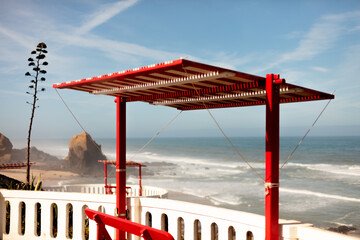 Red bench with ocean view in Santa Cruz, Torres Vedras, Portugal. 10 September 2025