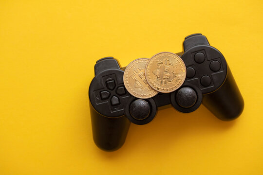 Crypto gaming concept. Video game controller with a bitcoin cryptocurrency coin
