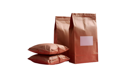 Set of copper-colored kraft paper packaging bags and pouches with a blank pink label isolated on transparent background.