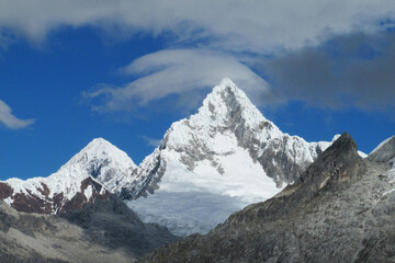 Fototapeta premium Huascaran mountain range in Cordillera Blanca, Peru near city Huaraz. Peruvian mountain summits. Snow and glacier mountains of Peru. Huascaran third tallest mountain in South America Peruvian Andes