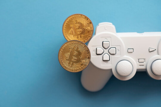 Crypto gaming concept. Video game controller with a bitcoin cryptocurrency coin