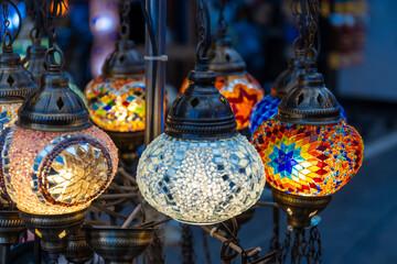 Lanterns colorful decorations. Turkish style different color lanterns at the Grand Bazaar in Istanbul. Illuminated festive lights © Yuliia