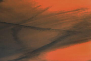 Traces airplane air trail jet line stripe sunset orange sky background
