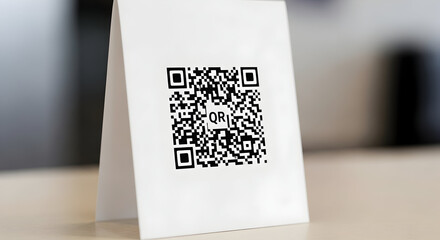Modern qr code displayed on a white stand for easy scanning