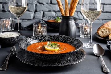 Elegant dinner setting with vibrant tomato soup