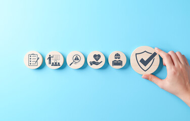 Work safety and compliance concept. Wooden blocks safety-related icons, including compliance, health, inspection, training, protection, regulatory, workplace safety, and risk management. Safety first,