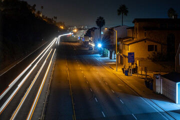 Time-lapse image of the northbound Pacific Coast Highway off the California Incline, Santa Monica, California. White and red light trails depict fast-moving traffic