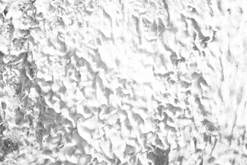 White marble texture. White water with ripples on the surface. Defocus blurred transparent white colored clear calm water surface texture with splashes and bubbles. Water waves with shining pattern.