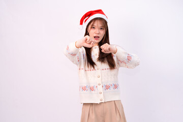 cheerful young pretty woman in santa hat celebrating the festive winter holiday or chirstmas in white studio background