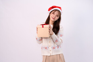 smiling young pretty woman holding gift boxes with santa head for christmas in white studio background
