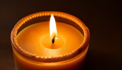 candle flame dancing on warm honey colored wax surface