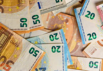 Close-up of mixed euro banknotes spread on table, representing European money, wealth, and economic concept.