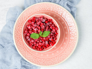 Frozen red currants in a plate.