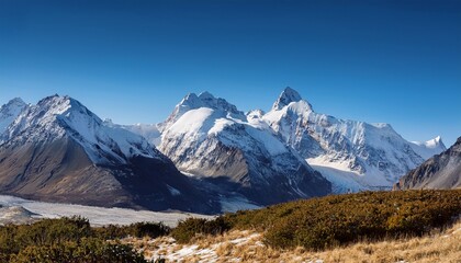 Fototapeta premium majestic snow capped mountains under a clear blue sky in a tranquil outdoor landscape