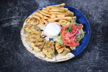 Halal Chicken Kabob with Fries, Pita Bread, Salad, and Garlic Sauce