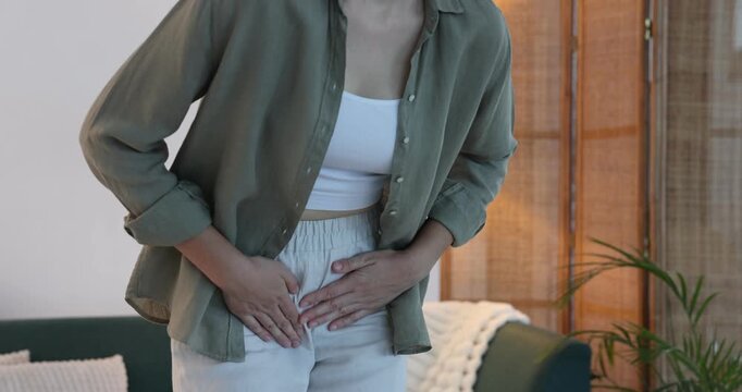 Woman suffering from cystitis symptoms at home, closeup
