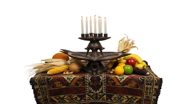 Kwanzaa celebration display with Kinara candles and harvest bounty.