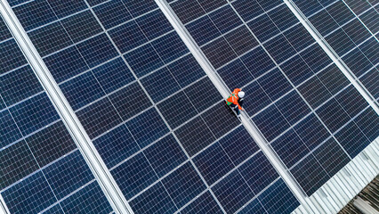 Engineers or technicians in safety gear meticulously inspecting and maintaining large-scale solar panel installations on a rooftop, emphasizing sustainable energy solutions.