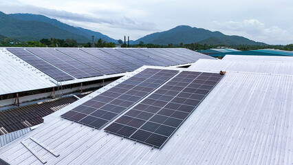 A commercial-scale photovoltaic (PV) solar array installed on an industrial building's roof. This...