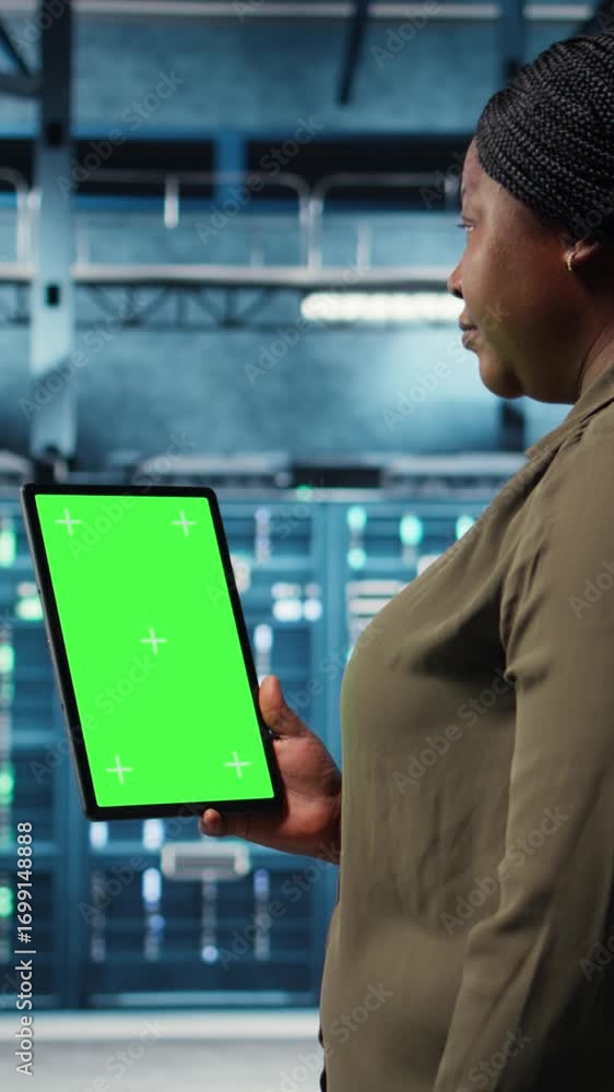 Aufkleber vertical video software developer at work using green screen tablet in data center to check hardware