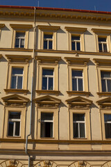 A very large building featuring a significant number of windows alongside an attractive red roof that enhances its overall appeal