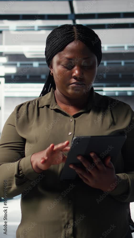 Poster vertical video technician using tablet in data center, integrating new technologies and systems. emp