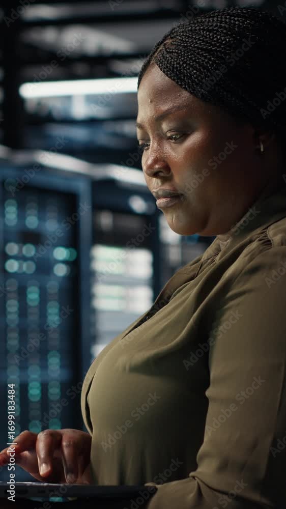 Aufkleber vertical video technician using laptop in high tech data center, integrating new technologies and sy