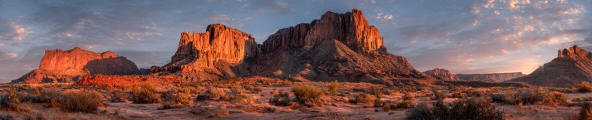 Majestic desert landscape at fiery sunset with dramatic shadows over iconic rock formations. Ideal for travel, nature, wall art, backgrounds, design, and creative visual projects.