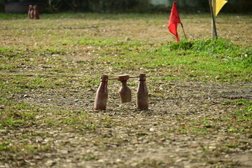 wooden bottle for petanque sport Thai style, equipment on green grass