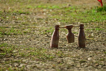 wooden bottle for petanque sport Thai style, equipment on green grass