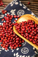 Organic Red Adzuki Beans in Wooden Spoon on Traditional Japanese Fabric