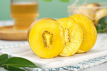 Fresh New Zealand Yellow Kiwifruit Slices on White Plate with Natural Light Background