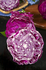 Fototapeta premium Fresh Purple Cabbage Cross Section with Feathery Layers and Natural Patterns on Wooden Background
