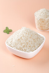 Long Grain White Rice in Bowls with Mint on Pink Background - Premium Agricultural Cereal Products