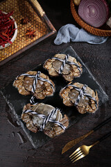 Fresh Taihu Hairy Crabs Closeup Display with Traditional Cooking Ingredients on Dark Slate Board