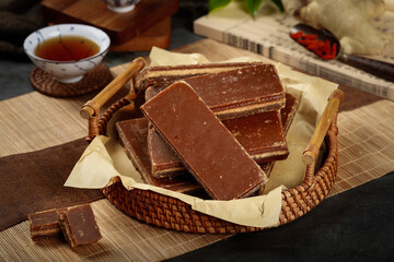Handmade Brown Sugar Chunks and Dark Cubes in Rustic Wicker Basket with Traditional Tea Setting